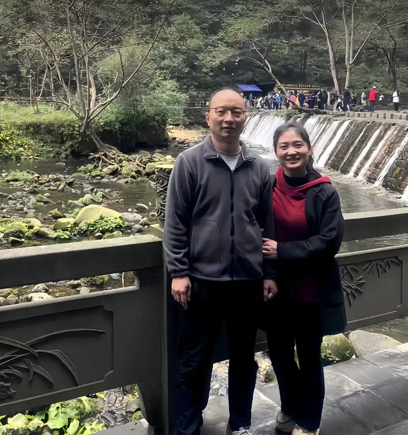 18年前,一对小夫妻在一个瀑布旁边合影.这是的他们30多岁,还很年轻.