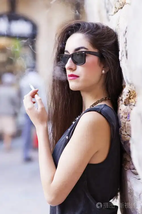 戴墨镜吸烟,复古风格的迷人黑发女子