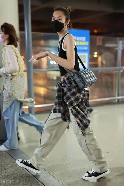 街拍:刘雯黑色背心 工装裤 格纹衬衫 帆布鞋率性休闲_机场