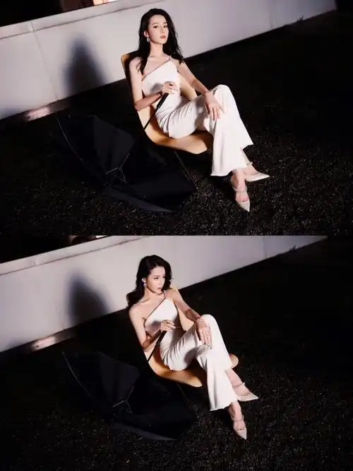 热巴穿斜肩连体裤撑黑伞 眼神霸气酷飒十足