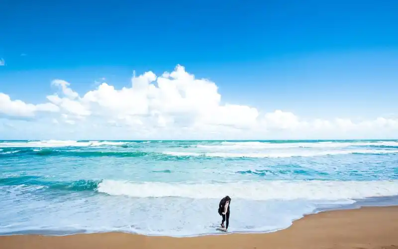 一个人在海边上漫步的图片