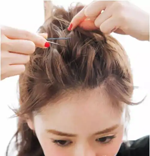 step1:树立好刘海之后,将头顶的头发取出在头顶扎一个高马尾.