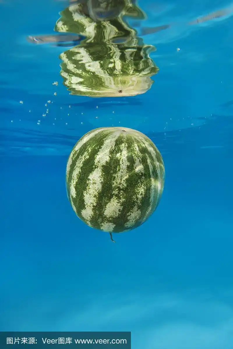 西瓜在蓝色的水中飞溅.水下拍摄